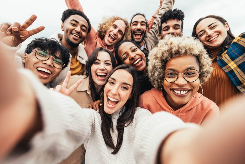 Big,Group,Of,Friends,Taking,Selfie,Picture,Smiling,At,Camera